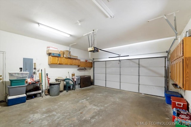 garage featuring a garage door opener and electric panel