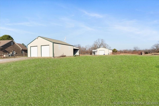 view of yard featuring a garage and an outdoor structure