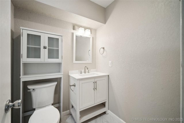 bathroom with toilet and vanity