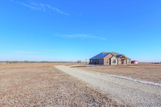 view of front of home with a rural view