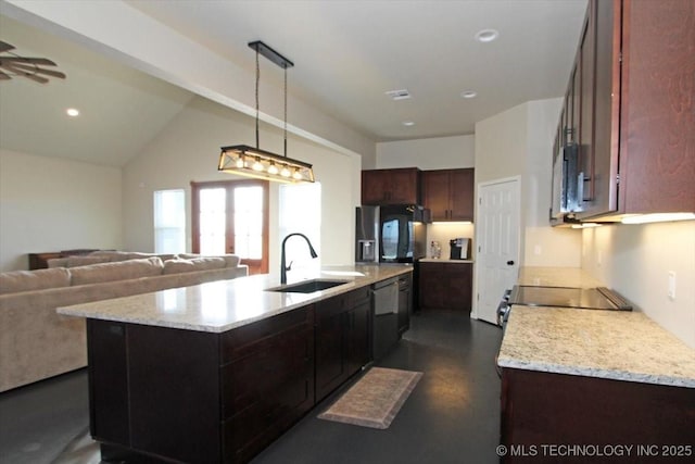 kitchen with a center island with sink, pendant lighting, range, and sink