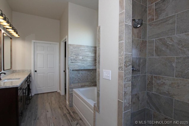 bathroom featuring vanity, wood-type flooring, and independent shower and bath