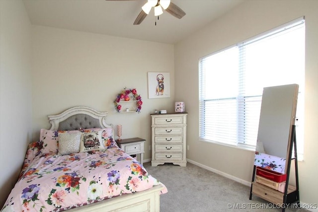 bedroom with ceiling fan and light carpet