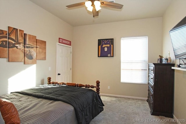 bedroom with ceiling fan, light colored carpet, and multiple windows