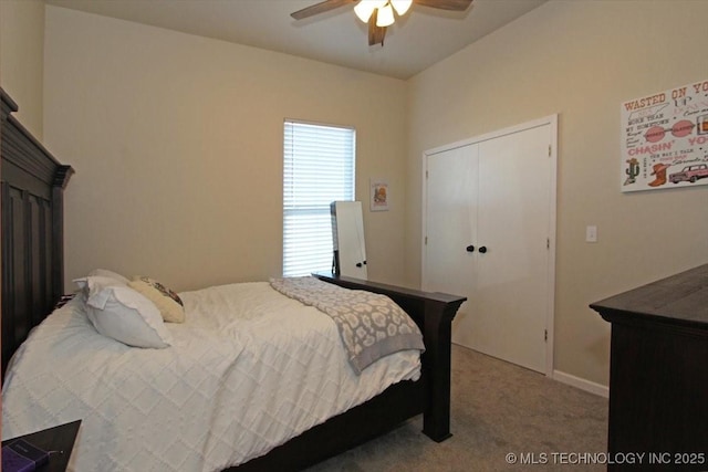 carpeted bedroom featuring ceiling fan and a closet