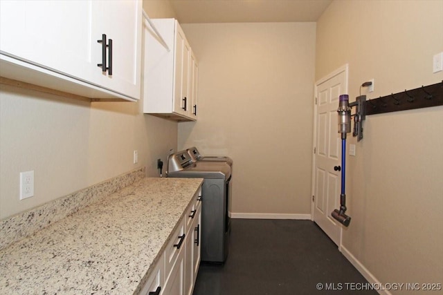 laundry room featuring cabinets and washing machine and dryer