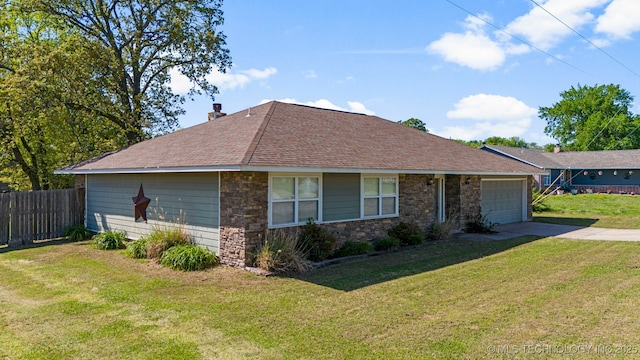 view of front of house featuring a garage and a front lawn