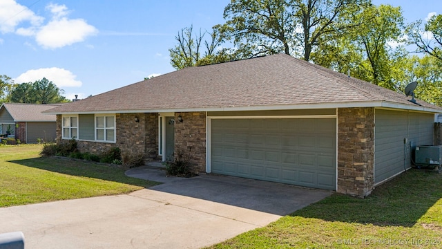 ranch-style house featuring central AC, a front yard, and a garage