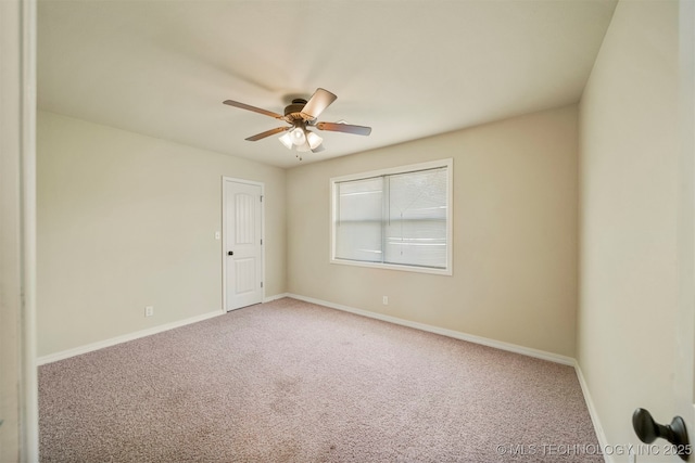 carpeted spare room featuring ceiling fan