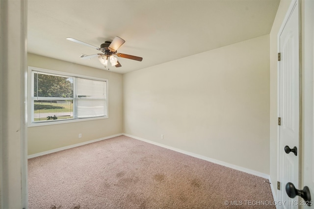 spare room featuring carpet and ceiling fan