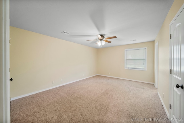 spare room featuring ceiling fan and light carpet