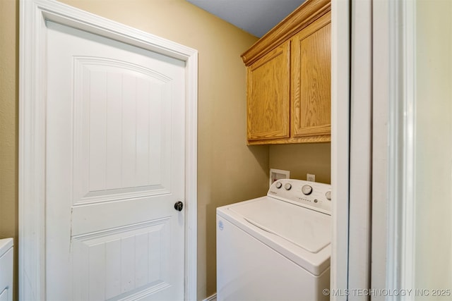 washroom featuring cabinets and washer / dryer