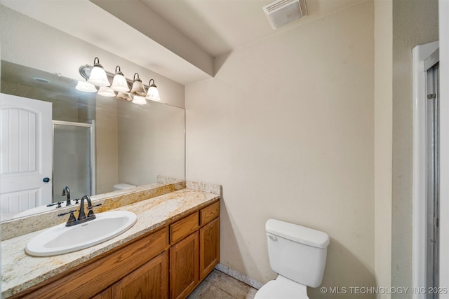 bathroom with tile patterned floors, vanity, toilet, and a shower with door