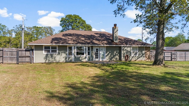 rear view of property featuring a yard