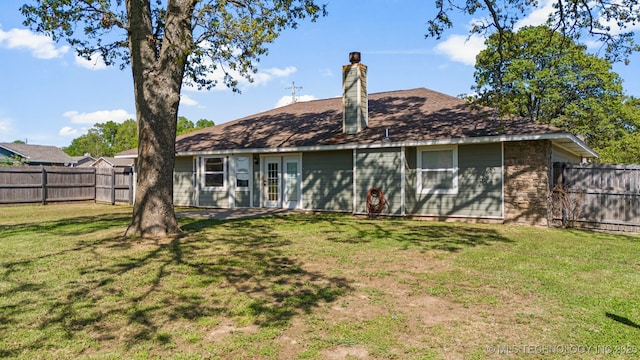 rear view of house featuring a yard