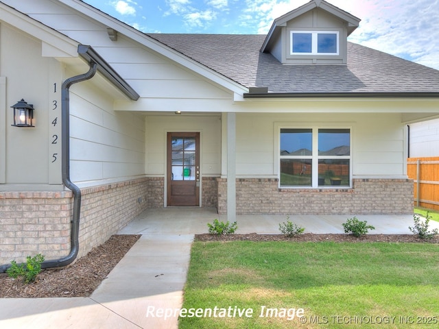 view of exterior entry featuring a lawn