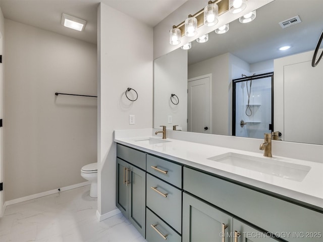 bathroom with a shower with door, vanity, and toilet