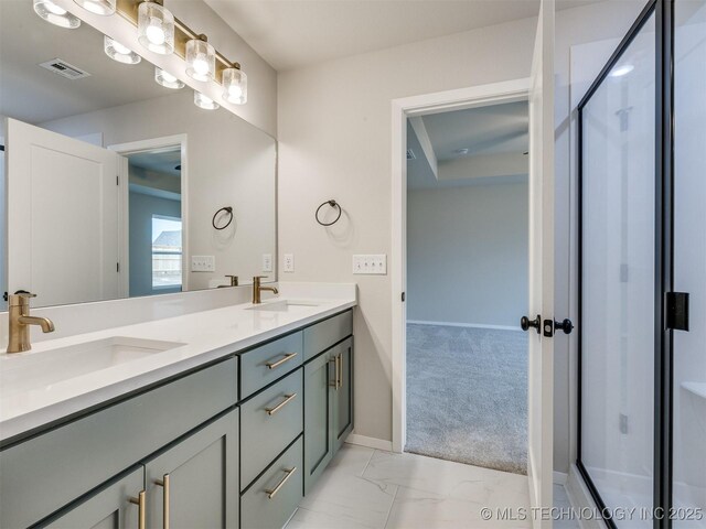 bathroom with vanity and a shower with door