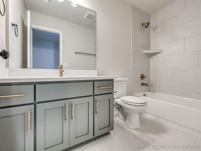 full bathroom featuring tiled shower / bath, vanity, and toilet