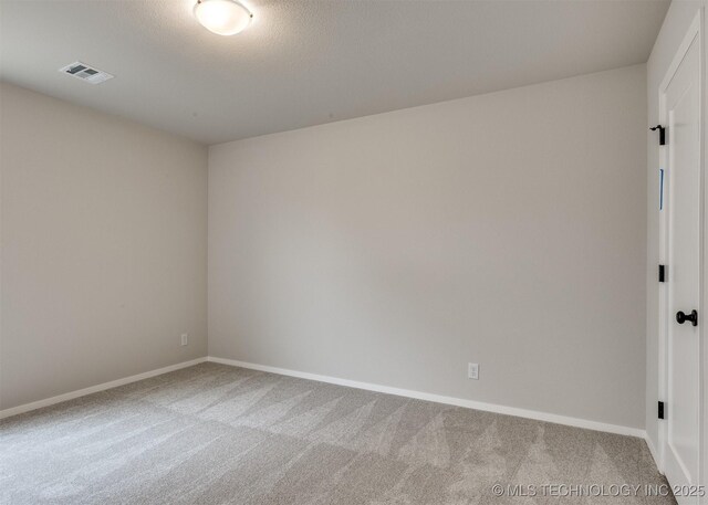 carpeted spare room with a textured ceiling