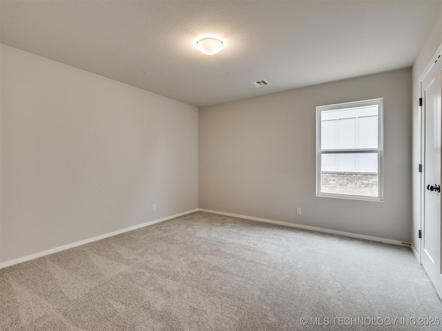 unfurnished room featuring light carpet