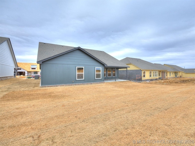 back of property featuring a patio and a lawn