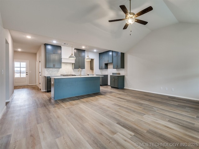 kitchen featuring a center island, pendant lighting, backsplash, and light hardwood / wood-style floors