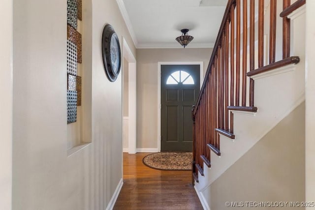 entrance foyer with dark hardwood / wood-style floors and ornamental molding