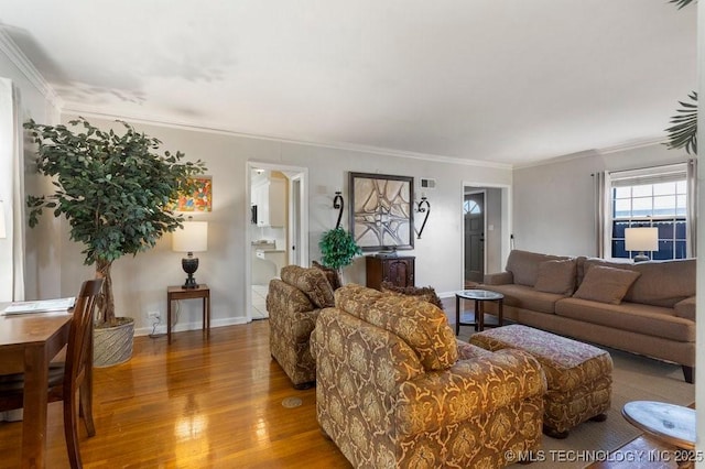 living room with hardwood / wood-style floors and crown molding