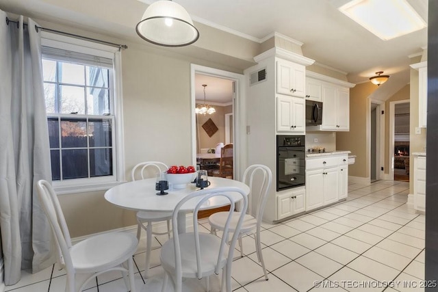 tiled dining space featuring crown molding and an inviting chandelier