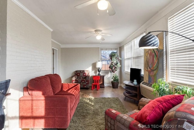 living room featuring ceiling fan, ornamental molding, and brick wall