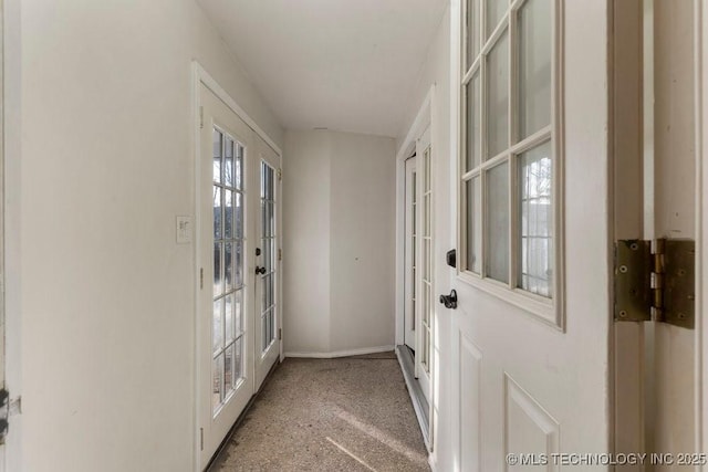 doorway to outside with light carpet and french doors