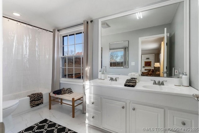 full bathroom with shower / tub combo with curtain, vanity, and toilet