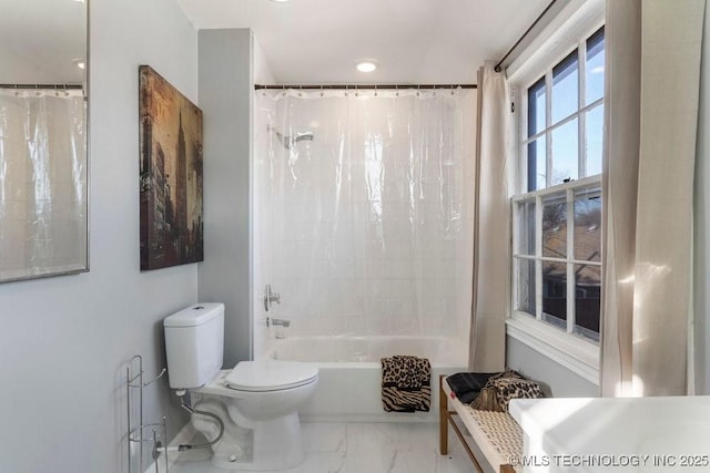 bathroom featuring toilet and shower / tub combo with curtain