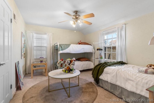 bedroom with ceiling fan, lofted ceiling, and carpet floors