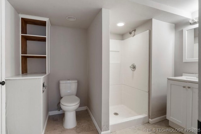 bathroom with a shower, vanity, and toilet