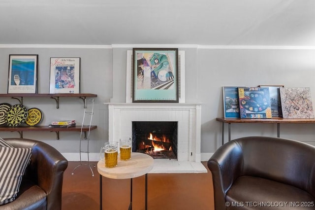 living area with a brick fireplace and ornamental molding