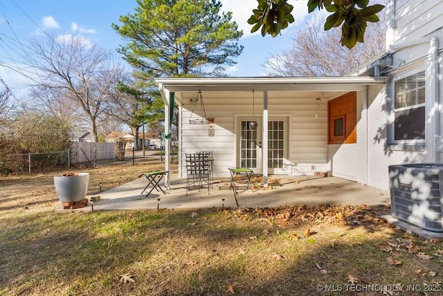 exterior space with central AC unit and a patio