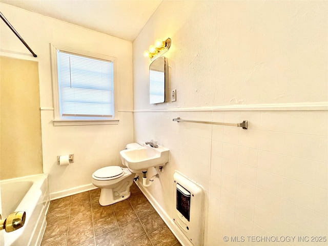 full bathroom with heating unit, toilet, tub / shower combination, and sink