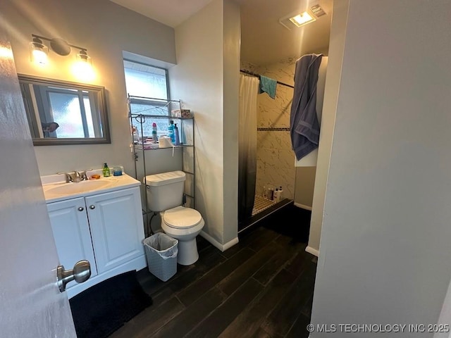 bathroom featuring a shower with shower curtain, vanity, and toilet