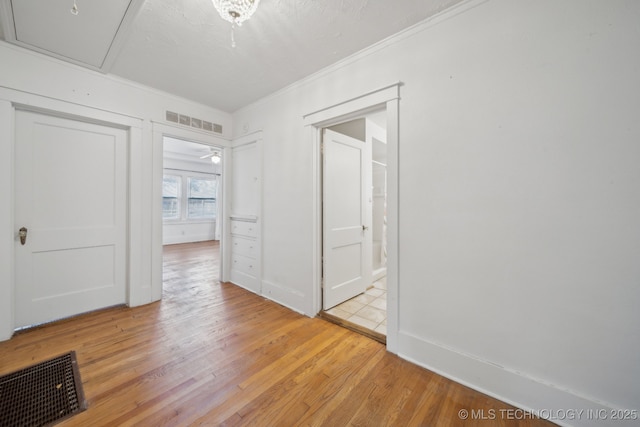 empty room with ceiling fan and light hardwood / wood-style flooring