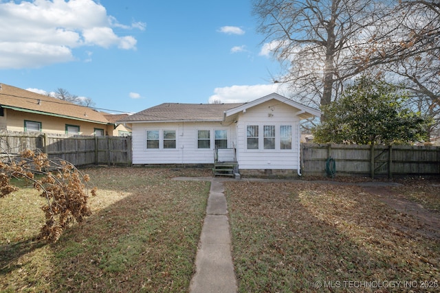 rear view of property with a yard