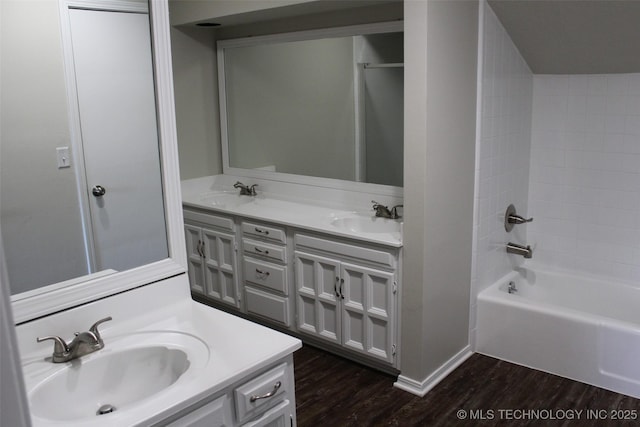 bathroom featuring vanity, wood-type flooring, and shower / tub combination