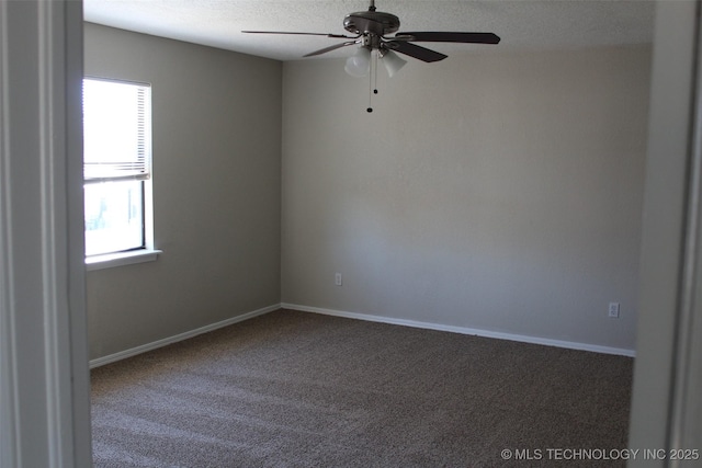 carpeted spare room with ceiling fan, a textured ceiling, and a wealth of natural light