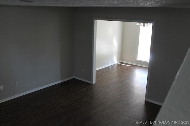 empty room featuring dark hardwood / wood-style flooring