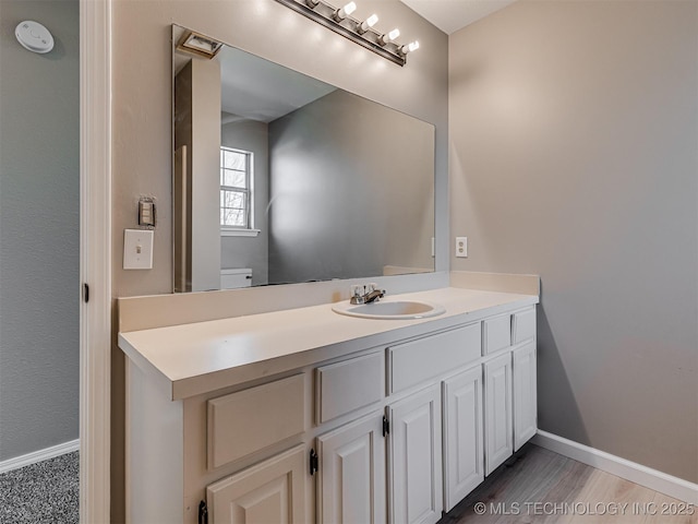 bathroom with vanity and wood-type flooring