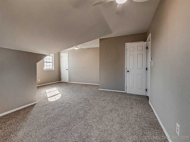 additional living space with carpet flooring, ceiling fan, and lofted ceiling