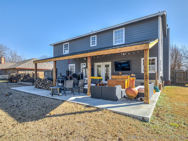 back of property with a patio area, an outdoor hangout area, and a yard