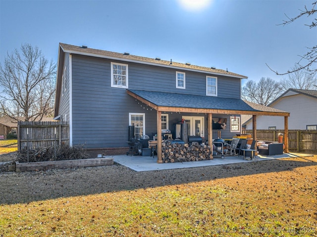 rear view of house with a lawn, a patio area, and an outdoor hangout area