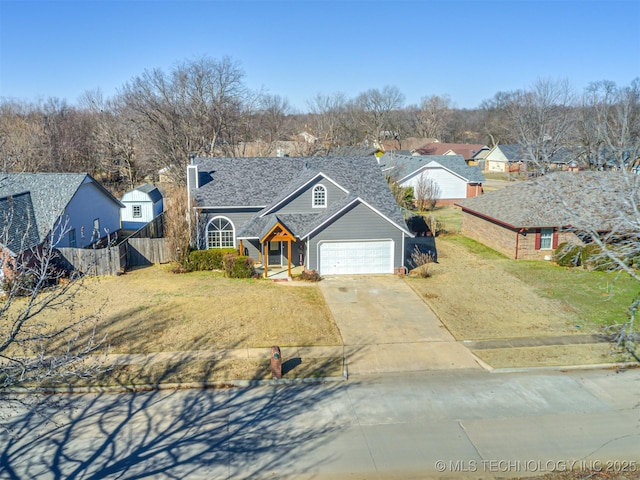 view of front of home featuring a front yard and a garage